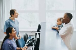 Doctors attending to a patient at the hospital desk - Direct Primary Care vs Concierge: Cost and Benefits