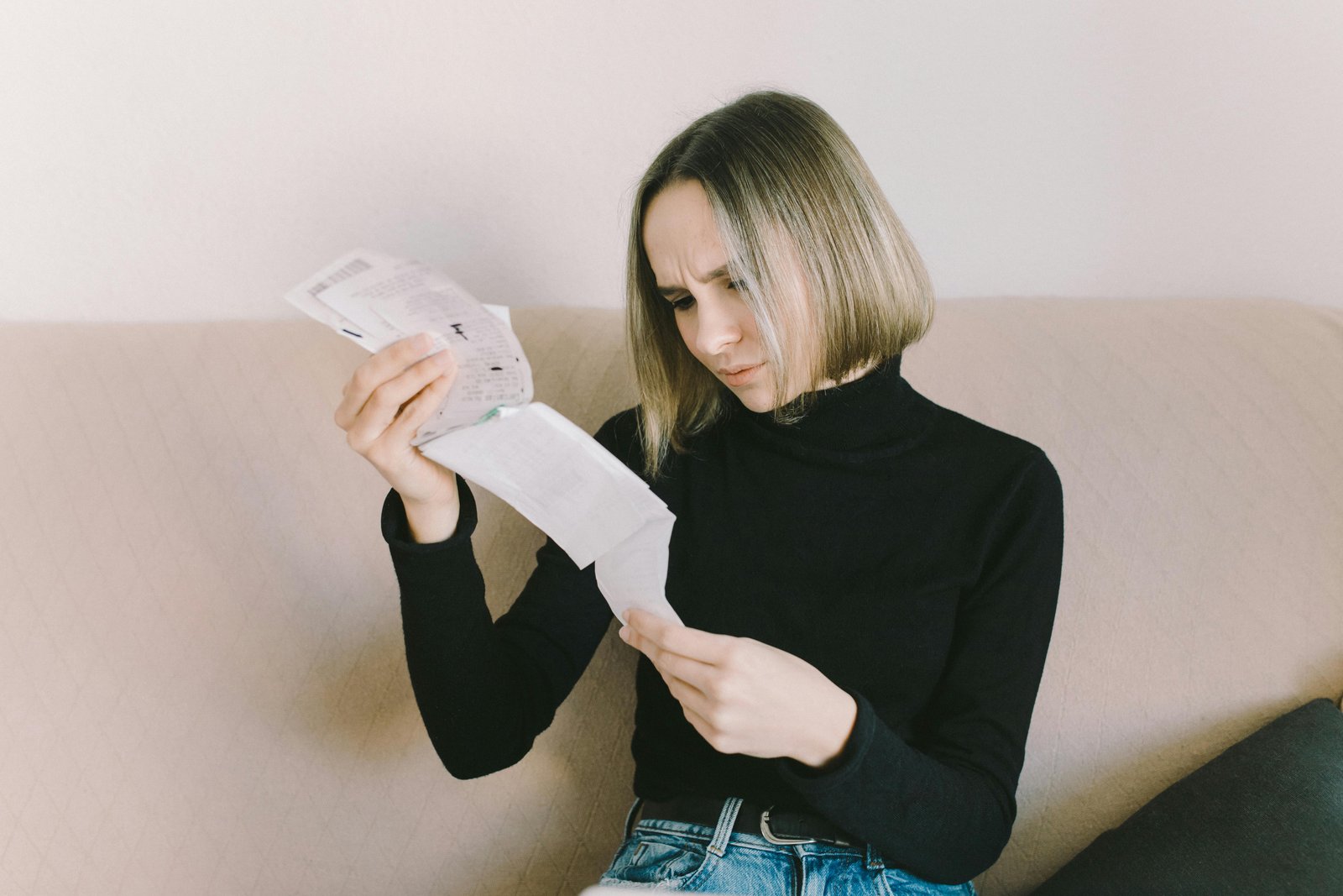 A Lady Looking at Her Receipts to Determine Factors Influencing Urgent Care Prices Without Insurance-6919698.jpg