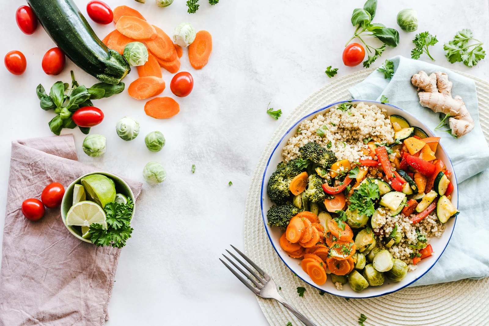 Picture Shows a Plate Containing Healthy Meal and Some Fruits on a Table 