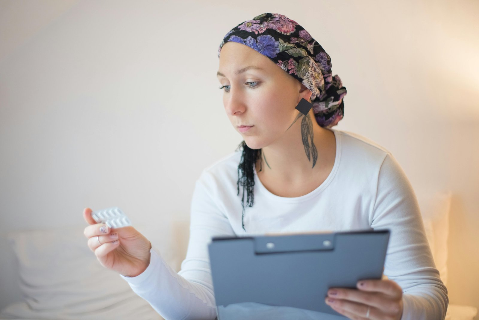 A Lady Reading the Writeup at the Back of a Tablet while Holding Her Medical Record on the Other Hand-8054061.jpg