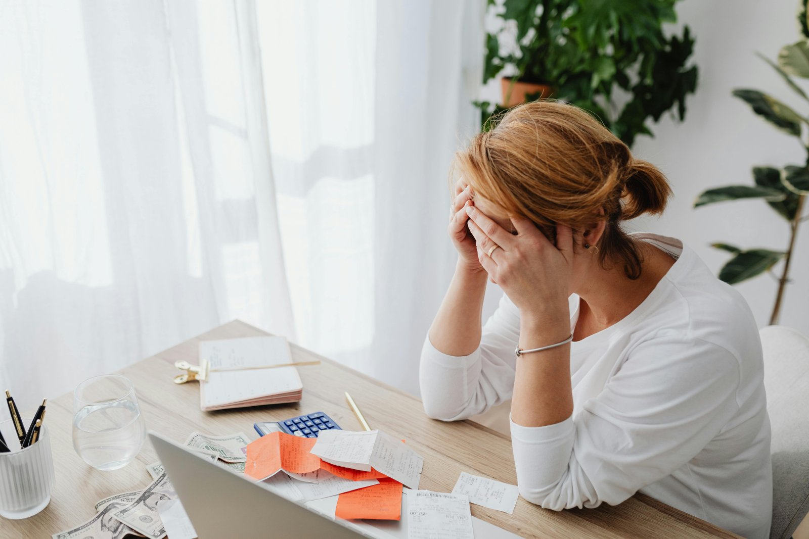 A woman sitting with her hands on her head-Why Is Uncoordinated Care a Problem-5900131.jpg