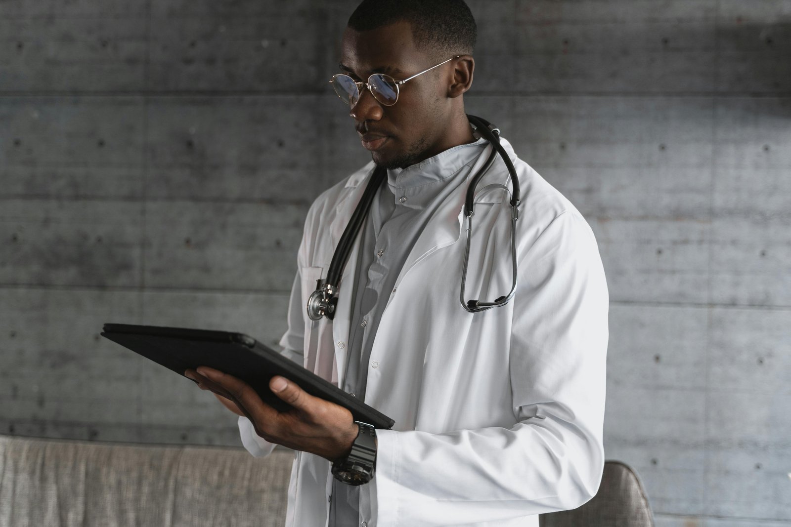 A Doctor Looking into His Tablet-Obesity Management in Primary Care