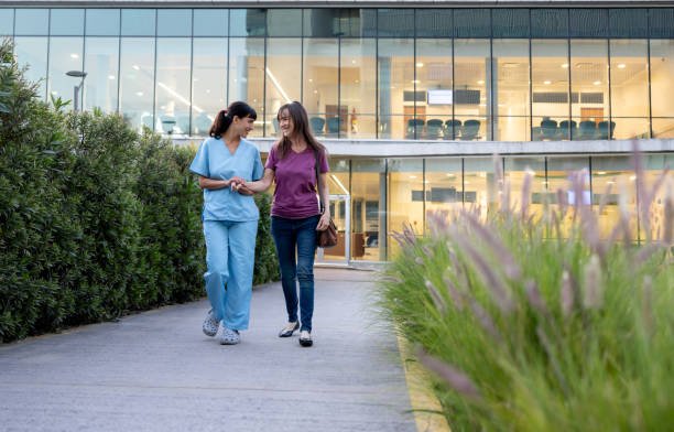  What Is the Most Affordable Health Care: Latin American nurse assisting a female patient in remission leaving the hospital 